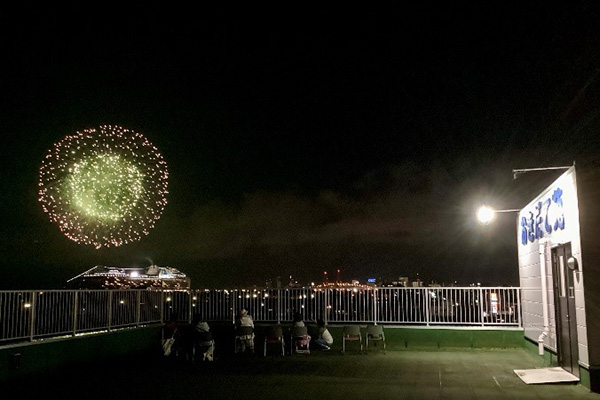 花火大会を屋上から見ている利用者たち