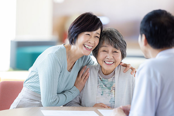 スタッフと談笑する高齢者と家族